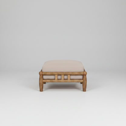 Wicker ottoman with a cushion on a white background