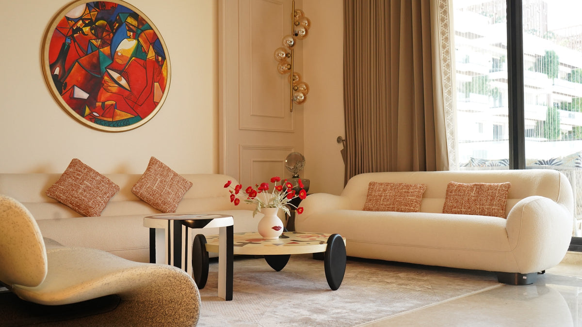Sculptural cream couches and a round coffee table in a client's living room
