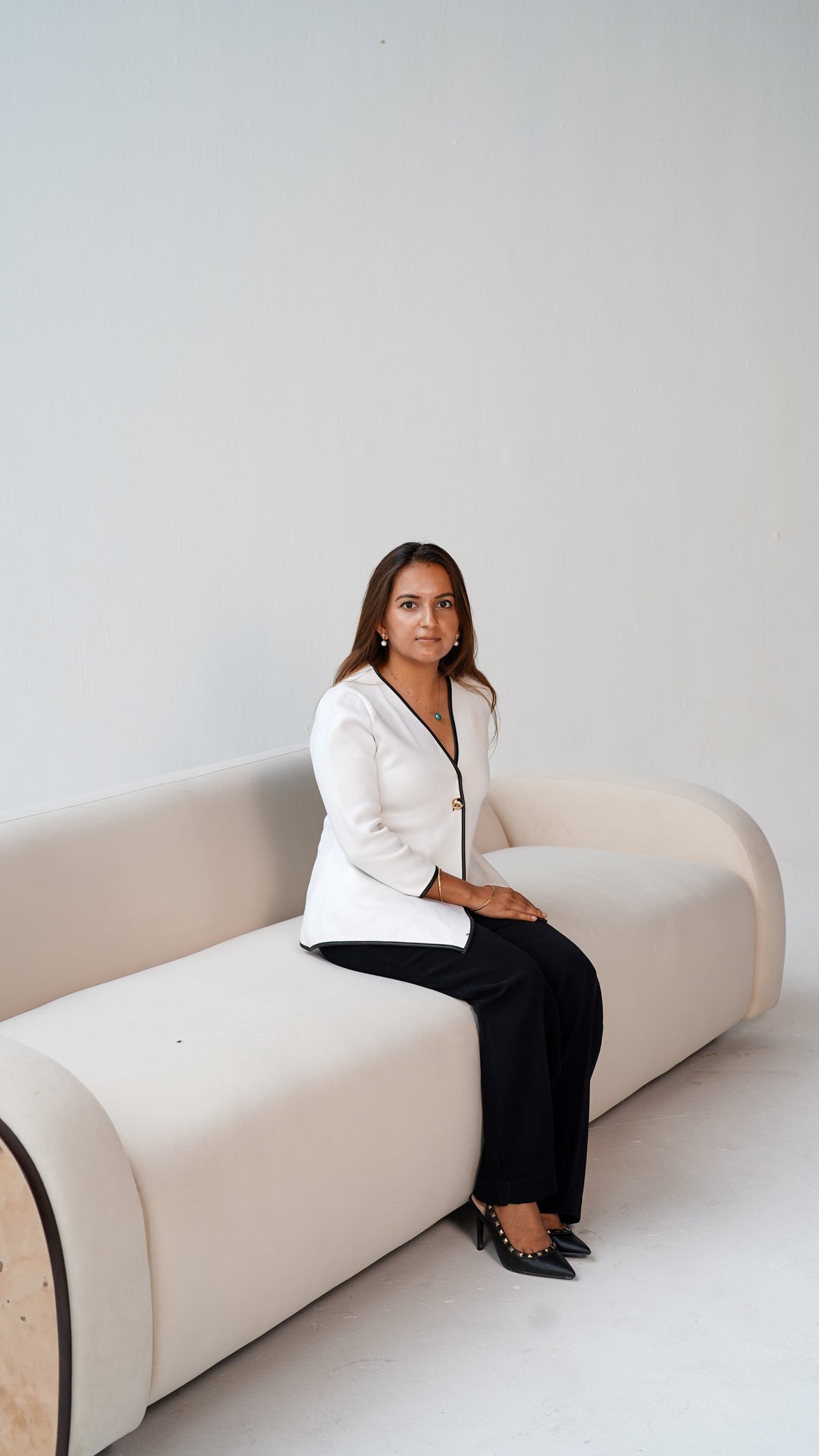 Shambhavi, founder of The Flamingo Life, seated on a Flamingo Life couch