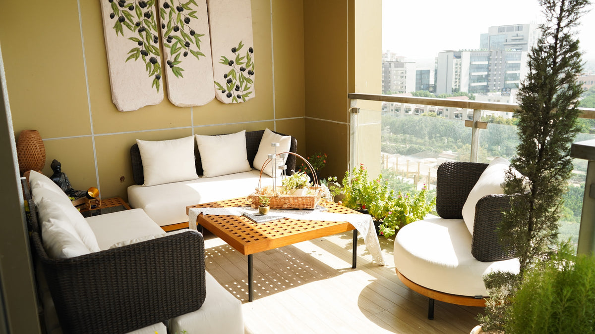 Outdoor sofas and a slatted coffee table on a sunlit balcony